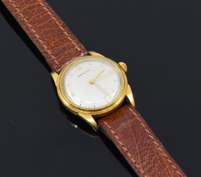 a gold plated wrist watch with a brown leather strap
