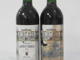two bottles of wine sitting next to each other on a table