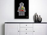 the lego man is sitting on the sideboard next to a vase