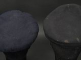 two hats sitting next to each other on top of a table