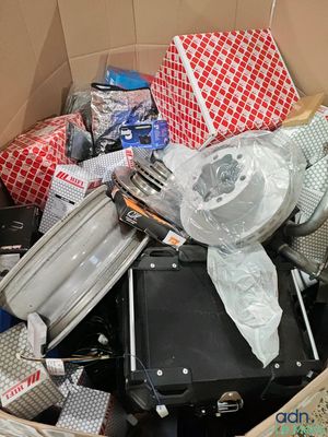 a cardboard box filled with many different types of luggage
