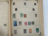 an open book with stamps on it sitting on a table