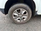 a white car with a flat tire on the road