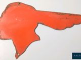 an image of a red metal bird head on a white surface