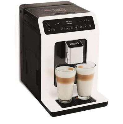 a close up of two cups of coffee in front of a coffee machine