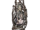 statue of a woman holding a baby in her arms with a tree in the background