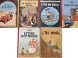 six children ' s books are lined up in a row on a white surface