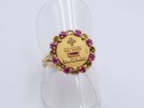 a close up of a gold ring with pink stones on it
