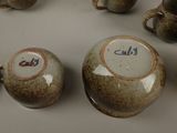 many cups and saucers that are sitting on a table