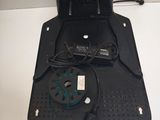 a green and black device sitting on a white table