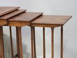 three wooden nesting tables sitting on top of each other on a white surface