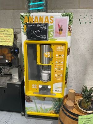 a yellow vending machine with a sign on the side of it