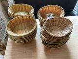 four wicker baskets sitting on top of a table next to each other