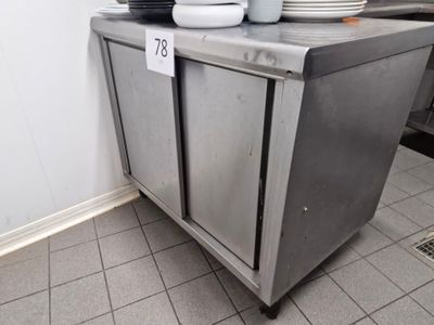 a stainless steel cabinet with plates on top of it