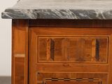 a wooden cabinet with a marble top on a hard wood floor