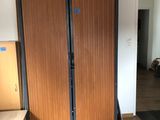 a room with a bed, a desk, and a closet