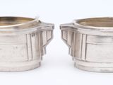 pair of silverplated sugar and creamers on a white background
