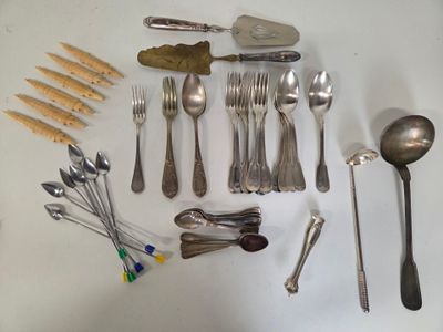 many different types of spoons and spoons laid out on a table