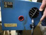 a person that is holding a blue machine in their hand