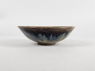 a close up of a small bowl on a white surface