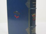 a blue book with gold trim on the cover