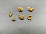 a set of five gold ear rings and a pair of earrings