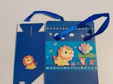 un sac cadeau bleu orné d'une image de lion