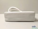 a white purse that is sitting on a table
