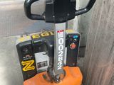 a small orange machine that is sitting on the sidewalk