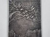 a picture of a silver plate with a picture of paris on it