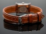 the brown leather bracelet has a silver clasp on it