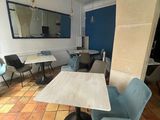 a table and chairs in a room with a blue wall