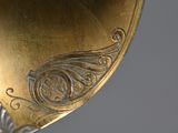 a close up of a gold plate with a design on it