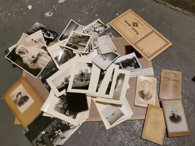 a pile of old black and white photos on the ground