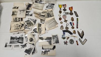 a lot of old photos and medals on the table