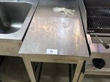 a stainless steel sink and a stainless steel stove in a kitchen