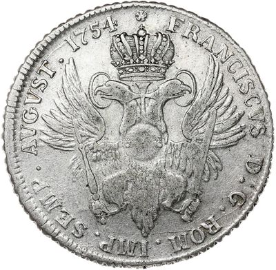 a close up of a silver coin with a crown on it
