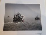 a picture of a boat in the water with other boats in the background