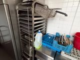 a kitchen with a stainless steel oven and a dish rack