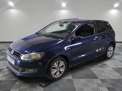 the blue volkswagen b - cross is parked on a checkered floor