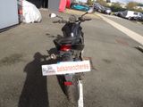 a motorcycle parked in a parking lot with a sign on it