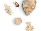 an image of a collection of ancient artifacts on a white surface