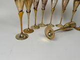 six gold wine glasses and a silver wine glass