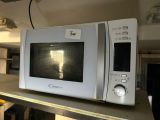 un micro-ondes posé sur une étagère dans la cuisine