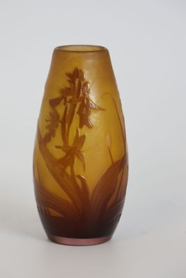 a glass vase with a design of flowers on it