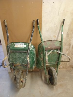 two wheelbarrows that are sitting next to each other