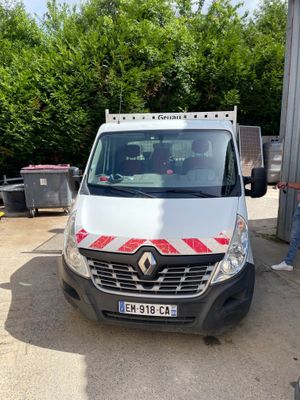 a white van parked in a parking lot with a man standing next to it