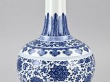 blue and white vase with floral design on the outside of it