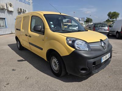 the small yellow van is parked in a parking lot near other cars