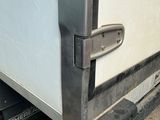 a close up of a door handle on a white refrigerator